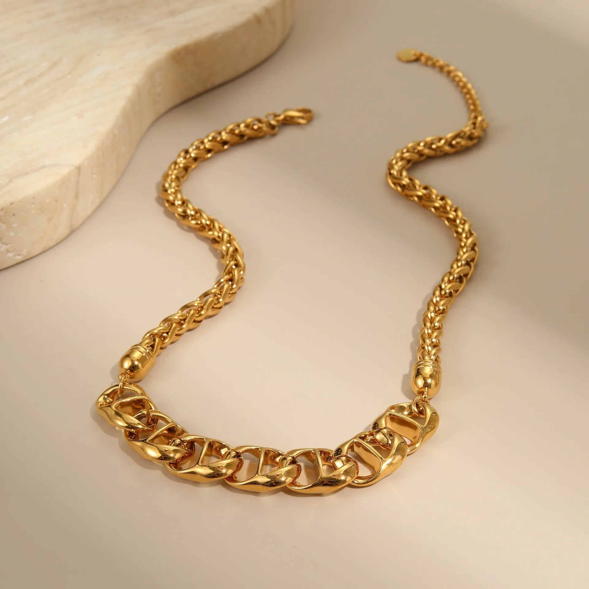 Gold and steel stainless steel geometric pendant necklace with regular chain.