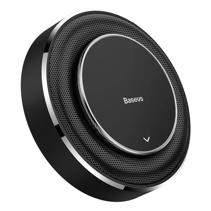 Round black aluminium alloy Bess car fragrance unit placed on a car seat.