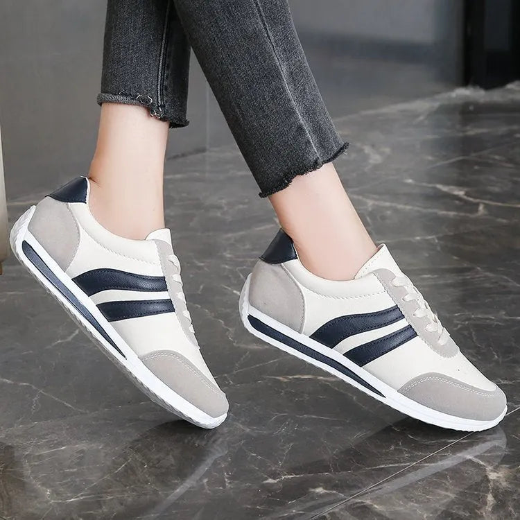 Blue and red low-top lace-up running sneakers with rubber soles and mesh upper