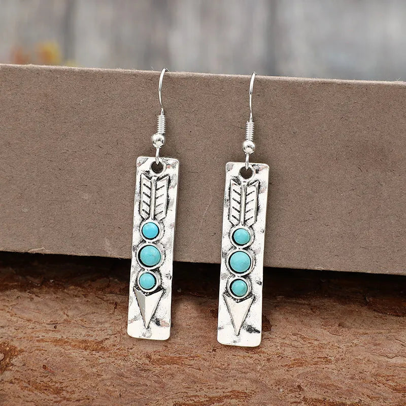 Women's silver geometric long strip earrings with turquoise detail and retro styling