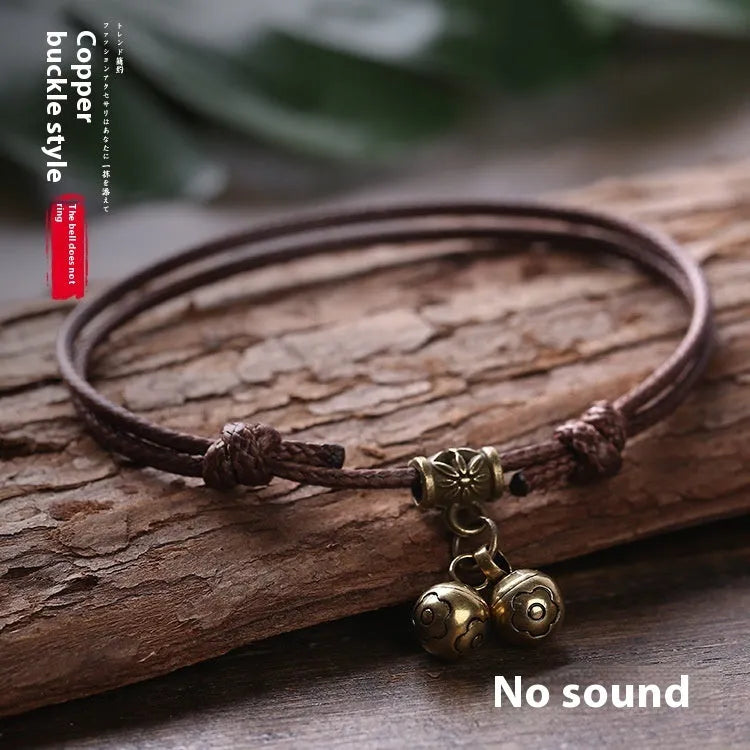 A nylon rope dog collar with a brass buckle shown alongside a version with a brass bell, in black, red, and coffee colours.