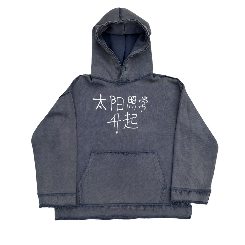 Reverse dark blue hoodie sweater on a model, showing knitted texture and hood.