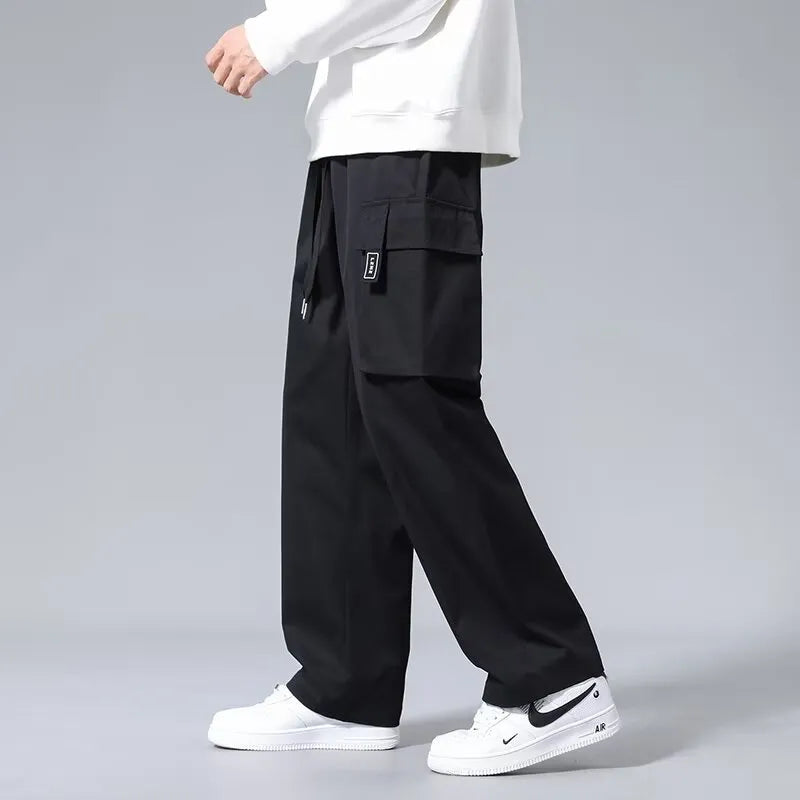 Boys' straight-leg cargo trousers in army green with large pockets and a drawstring waistband.