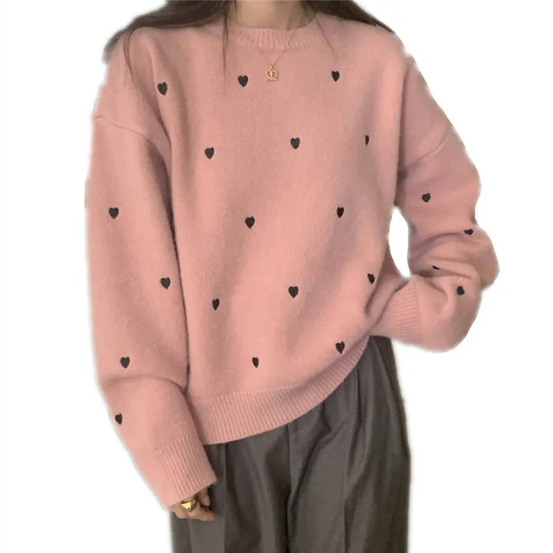 Women's loose fit acrylic pullover sweater in milky white, showing crew neck and long sleeve design.