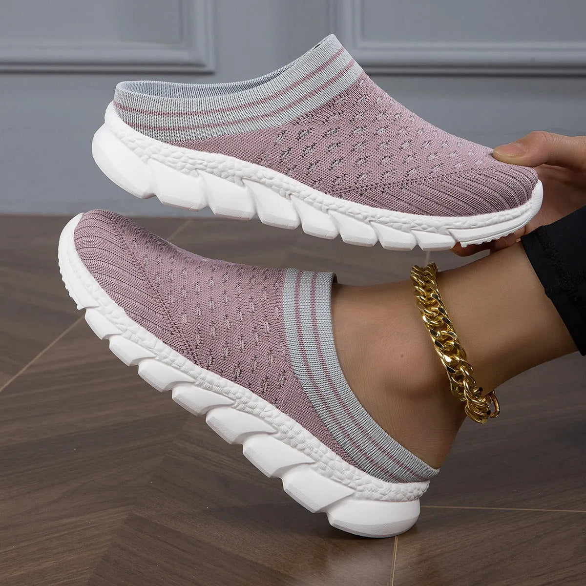 Women's black, pink, and purple Flyknit semi-slipper shoes with striped pattern and hollowed-out design.
