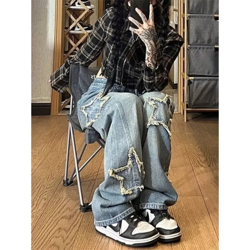 Blue women's high waist wide-leg denim jeans on a hanger, showing the straight leg cut.