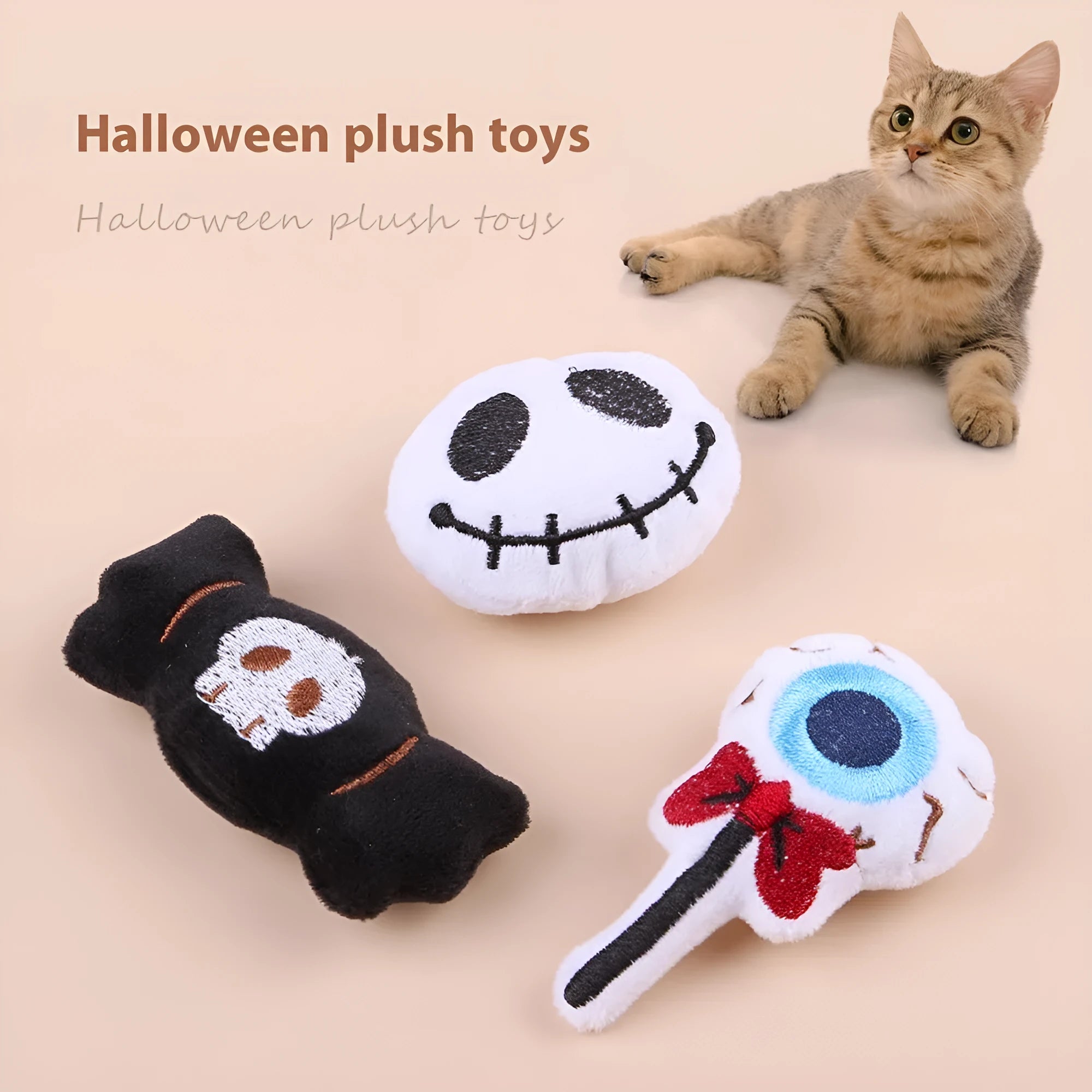 Small cat teaser wand toy with plush candy and skull attachments on string