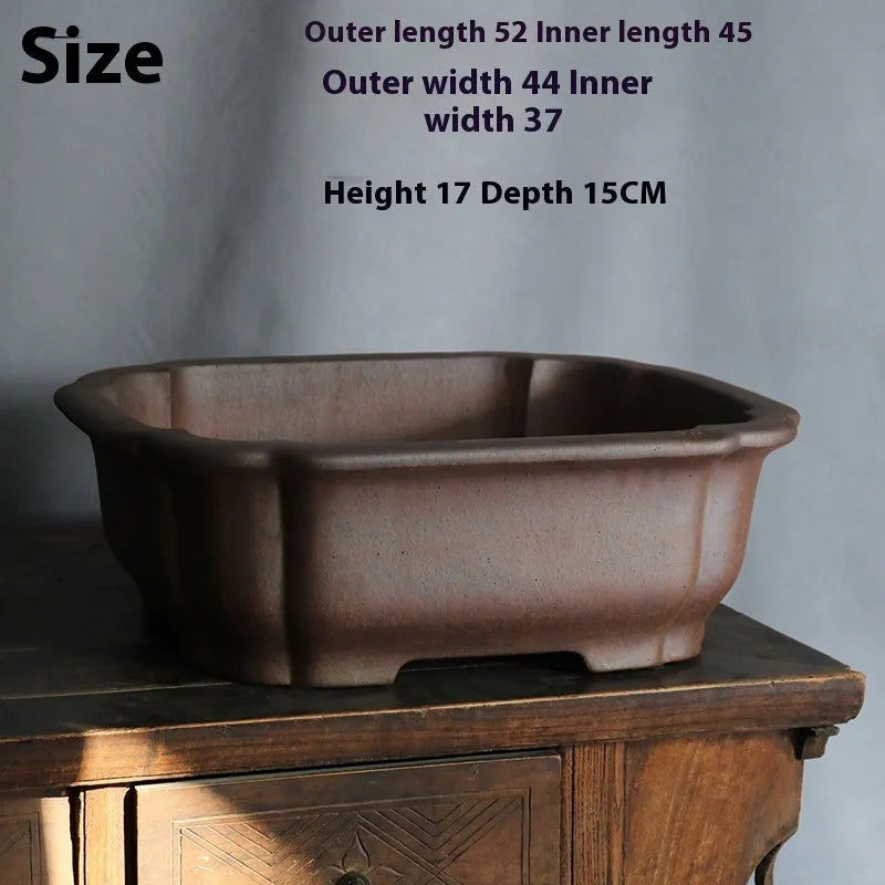 A rectangular purple sand clay bonsai pot on a floor, showing its modern simple design.