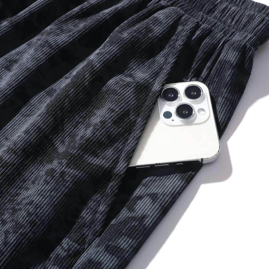 Men's camouflage pattern corduroy athletic shorts with a high waist on a neutral background.