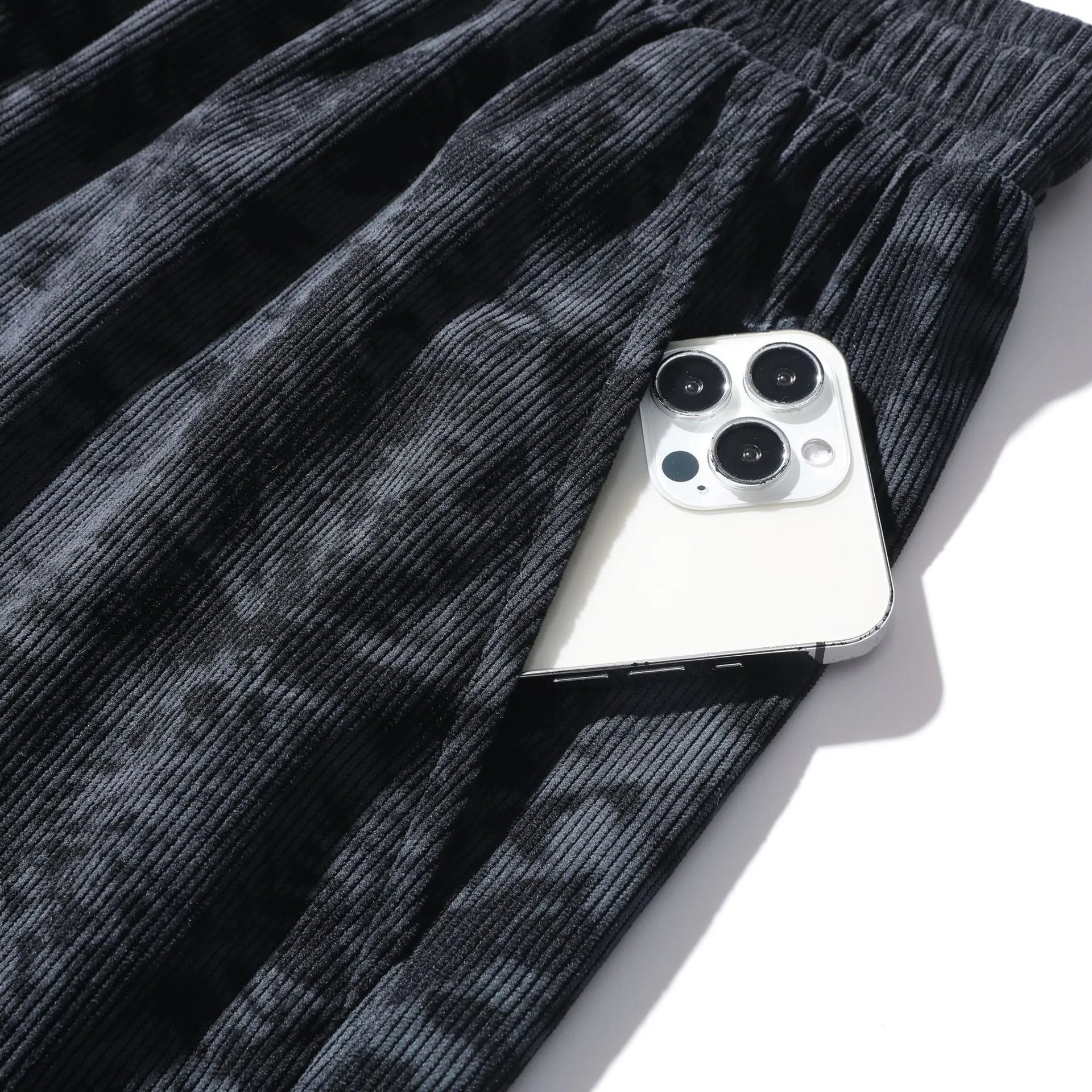 Men's camouflage pattern corduroy athletic shorts with a high waist on a neutral background.