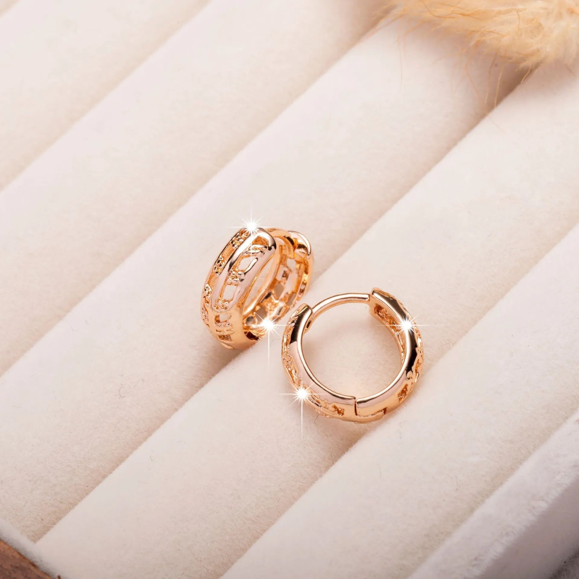 A pair of rose gold copper earrings featuring a hollowed-out leaf design with a heart shape detail.