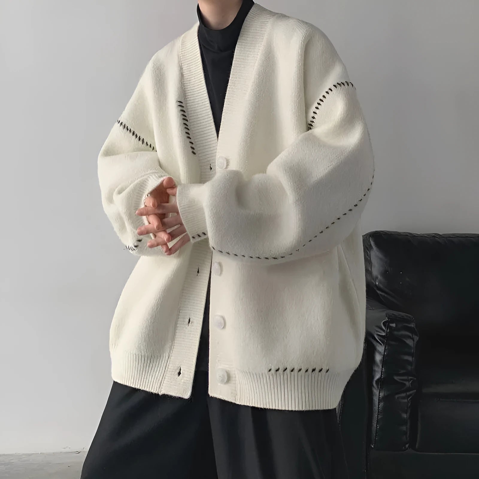 Women's loose-fit knitted cardigan coat in black or white.