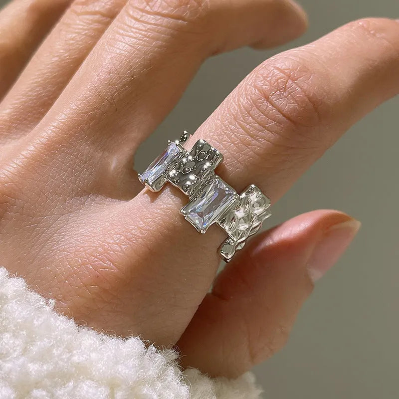 Silver geometric open ring with three-dimensional decoration and cross zircon design