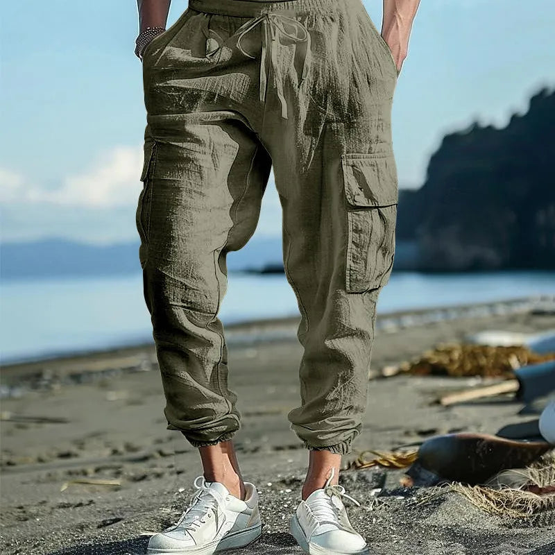 Men's linen casual trousers with ankle-tied cuffs and multiple pockets in a solid colour.