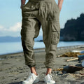 Men's linen casual trousers with ankle-tied cuffs and multiple pockets in a solid colour.