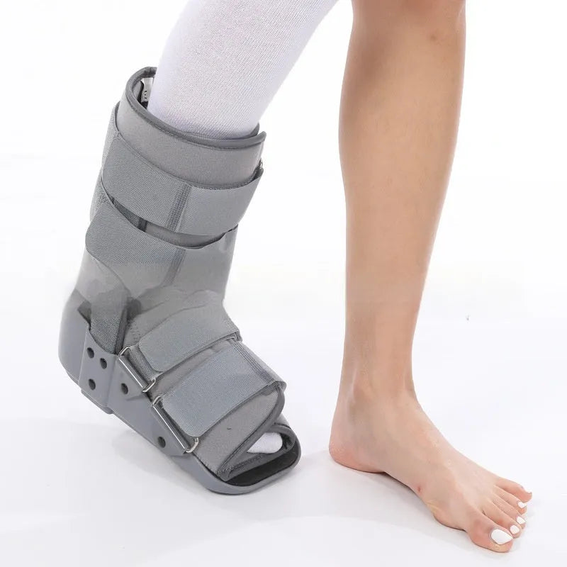 Grey and black Achilles tendon rehabilitation boot with adjustable straps and rocker sole for walking support.