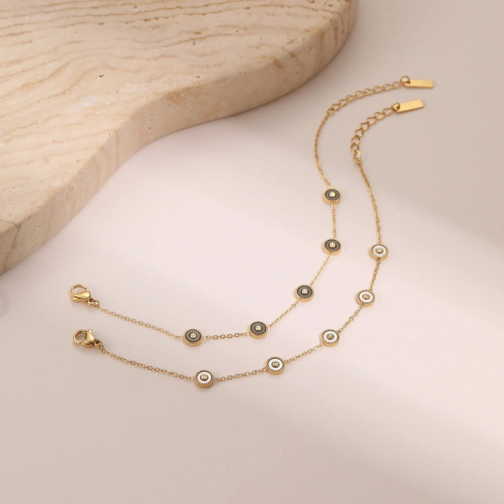 Gold-plated geometric fritillary design stainless steel bracelet and necklace set for women.