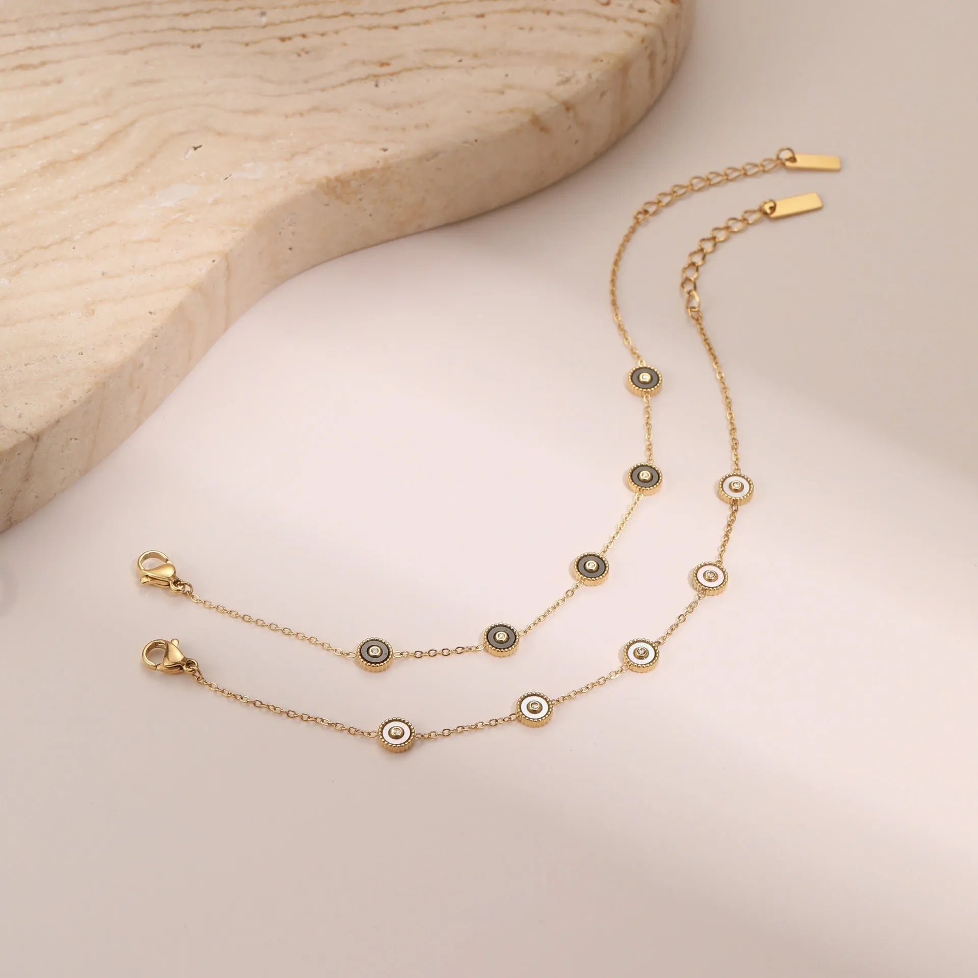 Gold-plated geometric fritillary design stainless steel bracelet and necklace set for women.