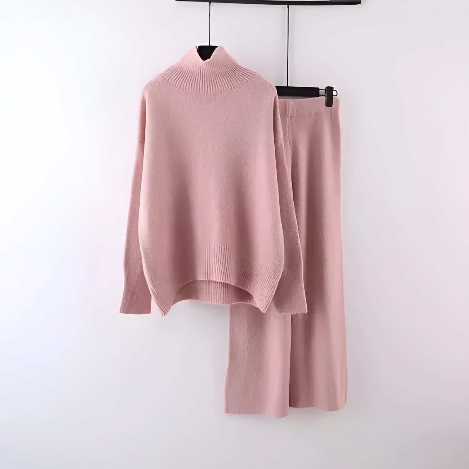 Women's milky white acrylic two-piece set with long sleeve top and wide-leg trousers on a hanger.
