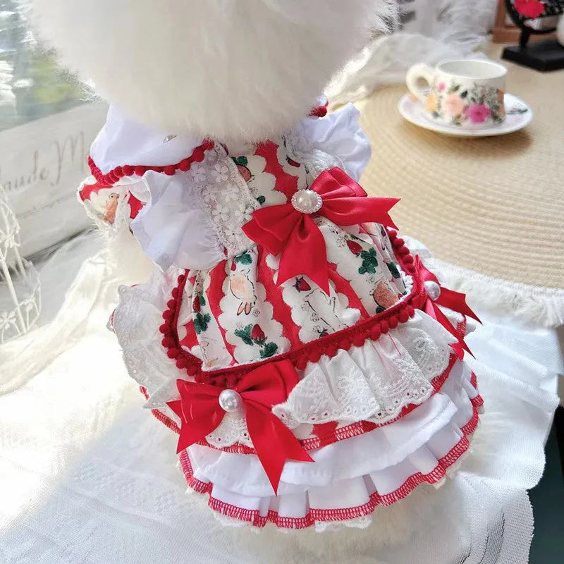Small white dog wearing a pink rabbit-themed princess skirt with layered fabric.