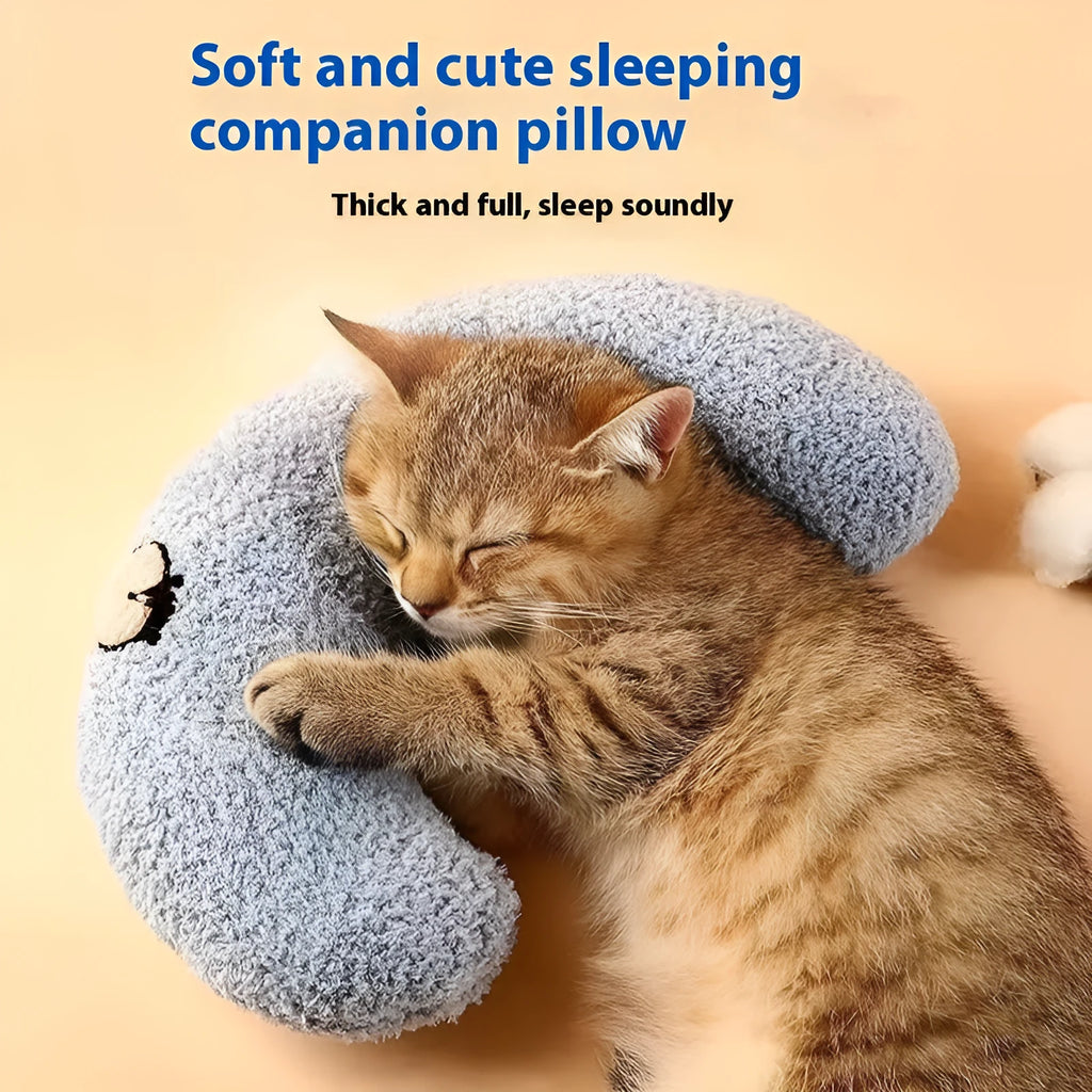 Blue and yellow question mark shaped cat bed with a U-shaped pillow for neck support on a wooden floor.
