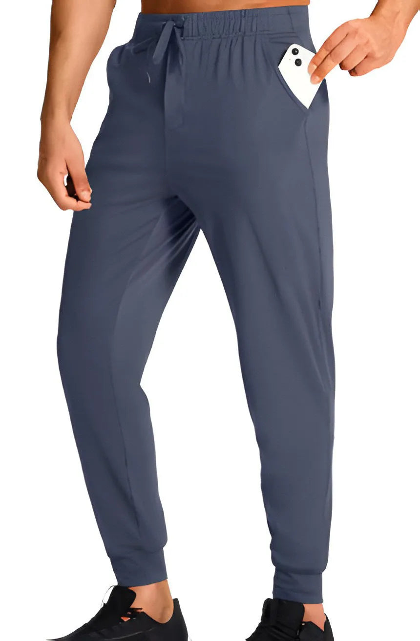Men's loose fit casual trousers in solid colour polyester fabric showing relaxed cut and casual styling
