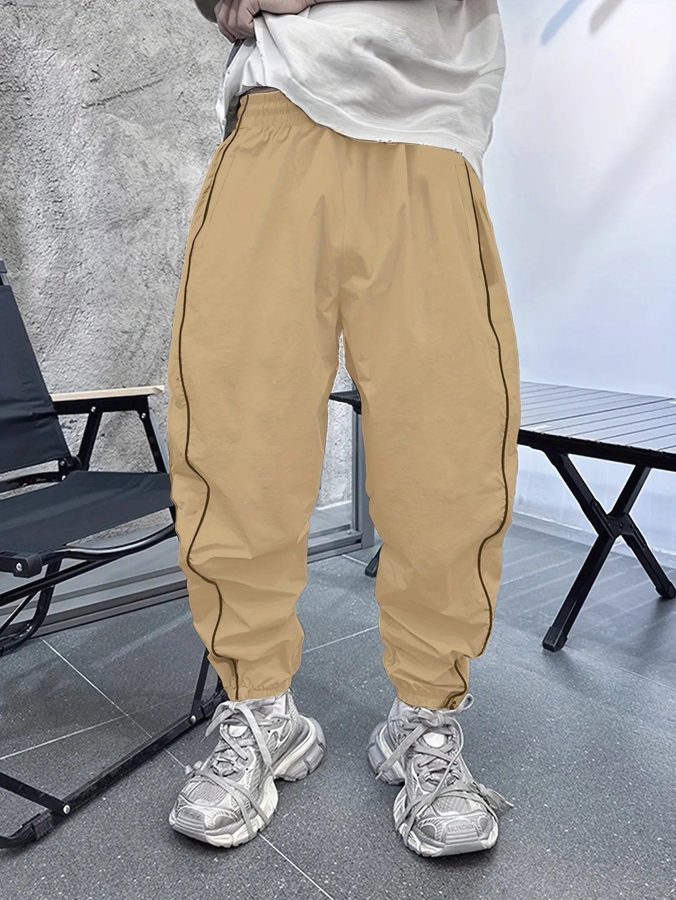 Men's blue bamboo fibre casual sports trousers with cropped length and loose fit on a hanger.