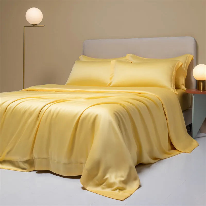 Luxury Lenzing Tencel bedding set in Aurora Blue on a bed, showing quilt cover, sheet, and two pillowcases.