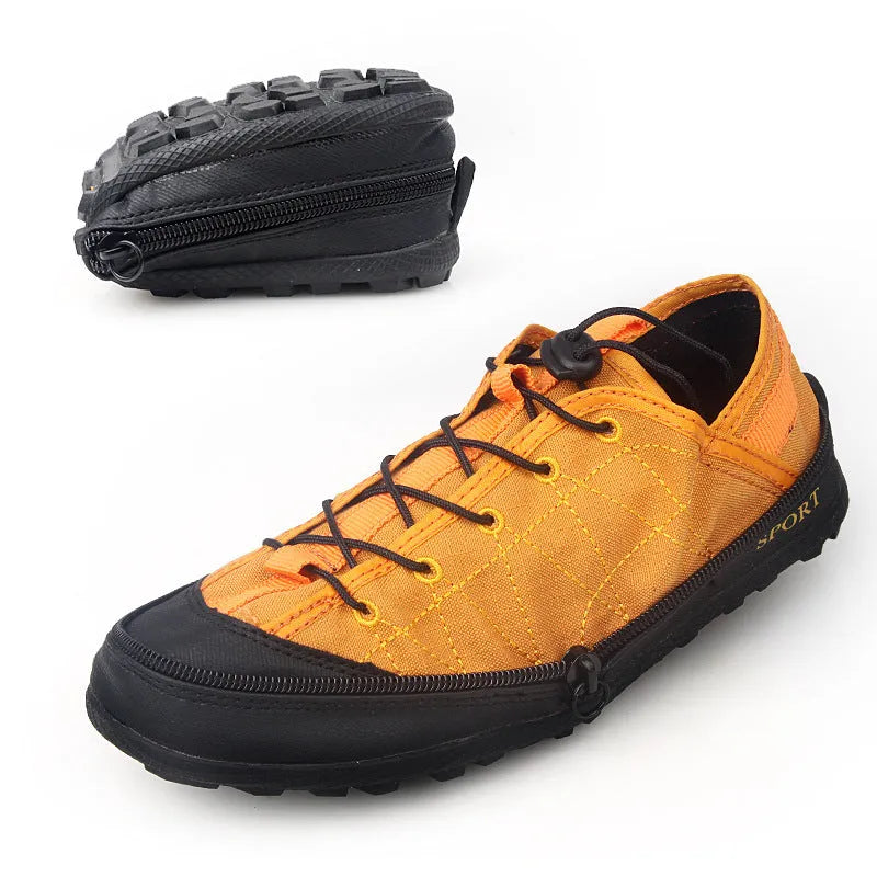 Orange folding outdoor hiking shoe with mesh upper and side zip closure laid flat.