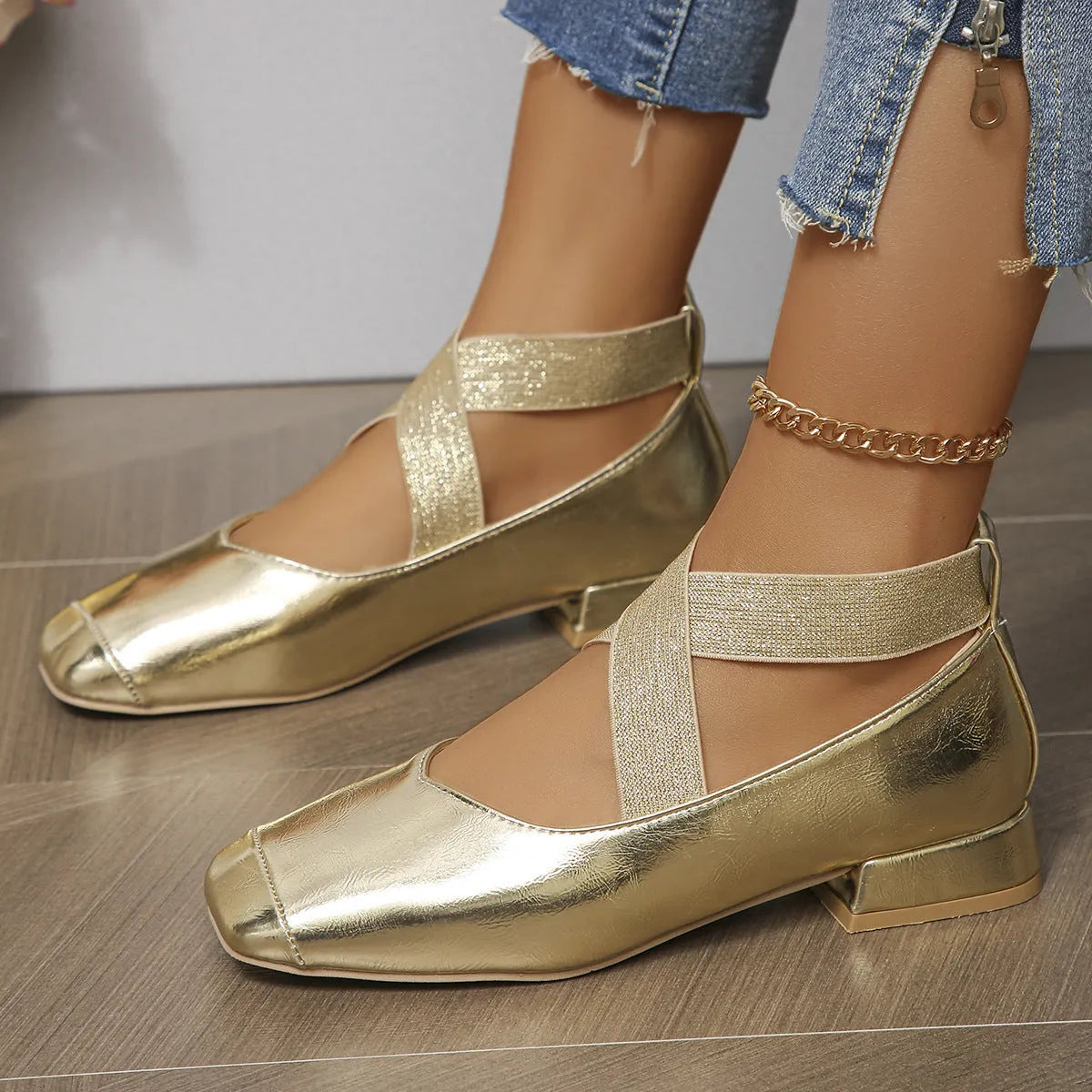 Gold women's slip-on evening pumps with skirt detail, square toe, and low rubber heel