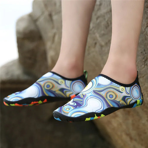 Blue Lycra beach wading shoes with EVA sole for men and women, shown on a sandy background.