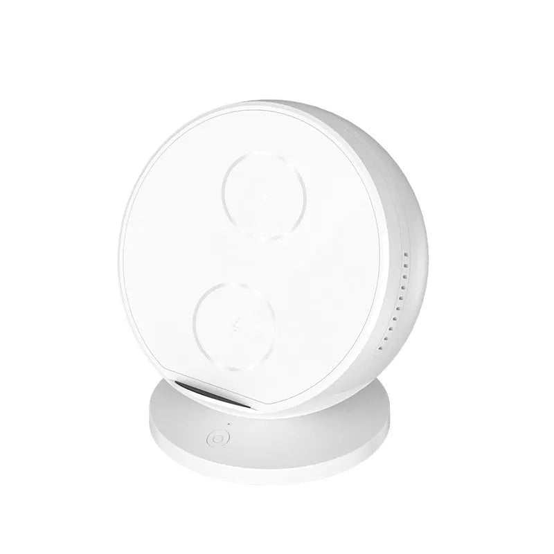 Black multifunctional wireless charging phone holder with built-in Bluetooth speaker on a desk.