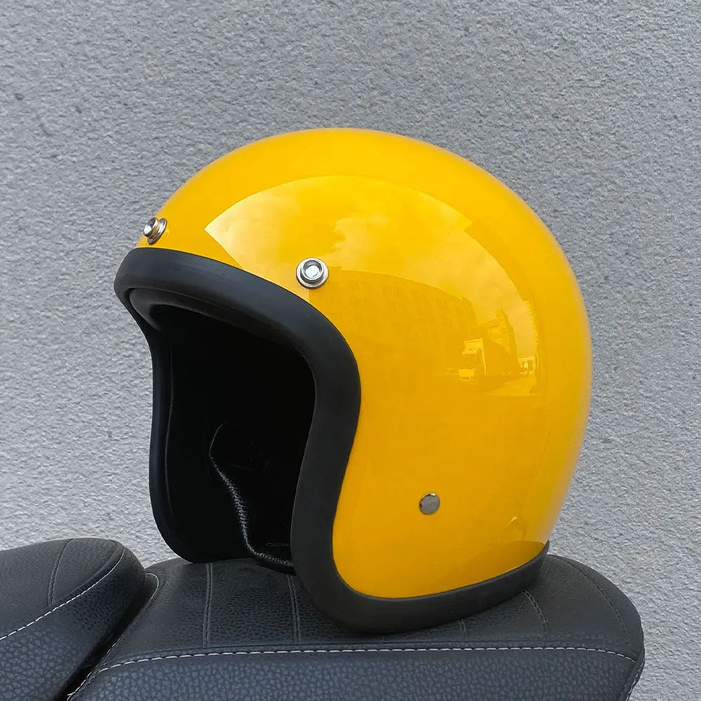 Retro-style open-face motorcycle helmet in fibreglass, shown in a choice of colours including Cement Grey and Matte Black Flower.