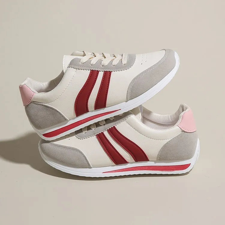 Blue and red low-top lace-up running sneakers with rubber soles and mesh upper