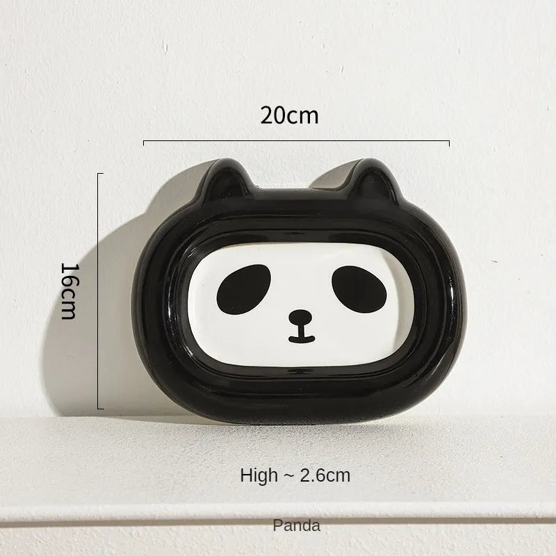 Glazed ceramic pet food bowl with animal design and non-slip rubber base ring.