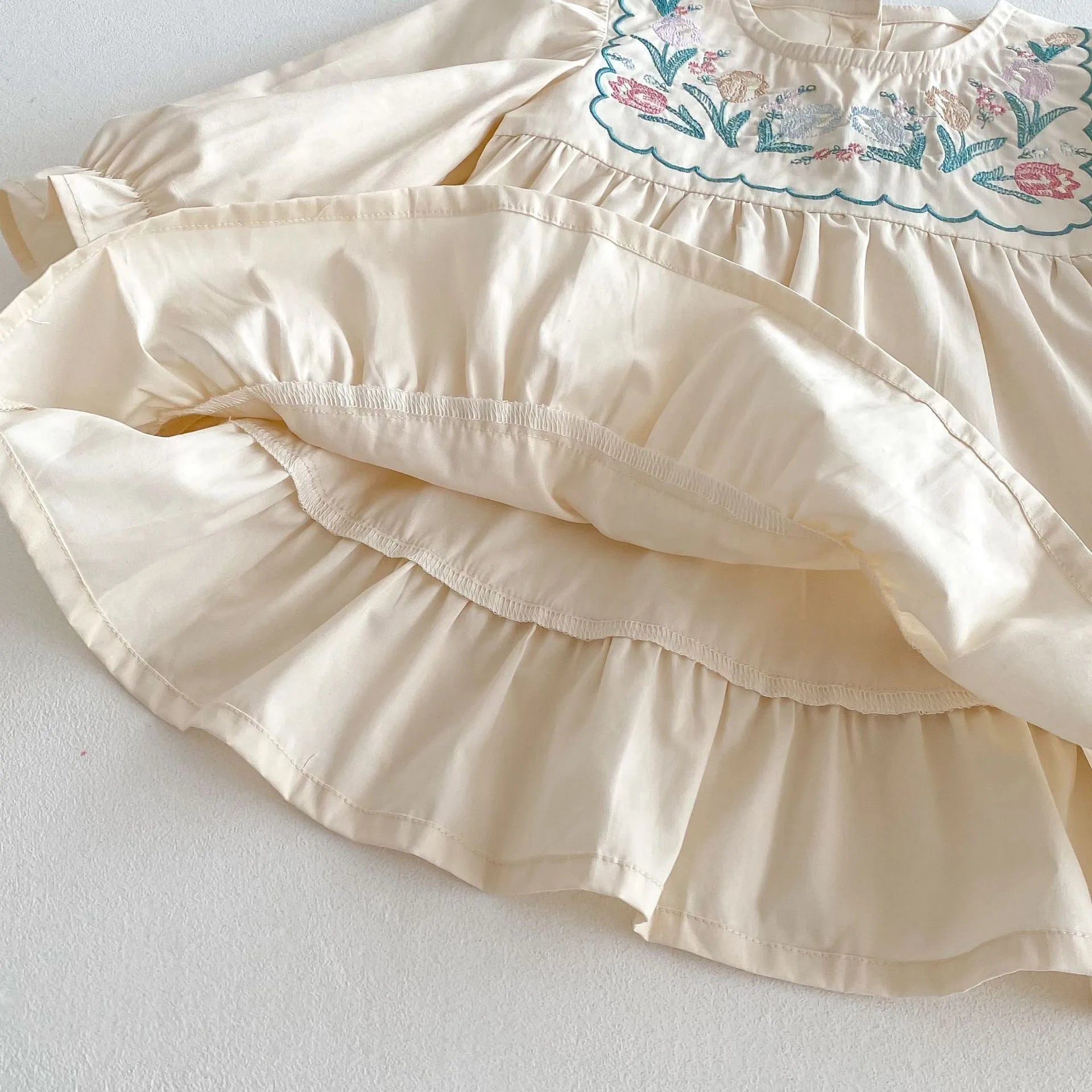 Girls' ruffled long sleeve flower embroidered princess dress in apricot colour on a child model