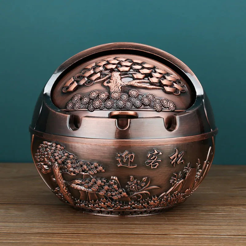 Bronze alloy ashtray with decorative fortune tree design and smoke extinguishing slot.