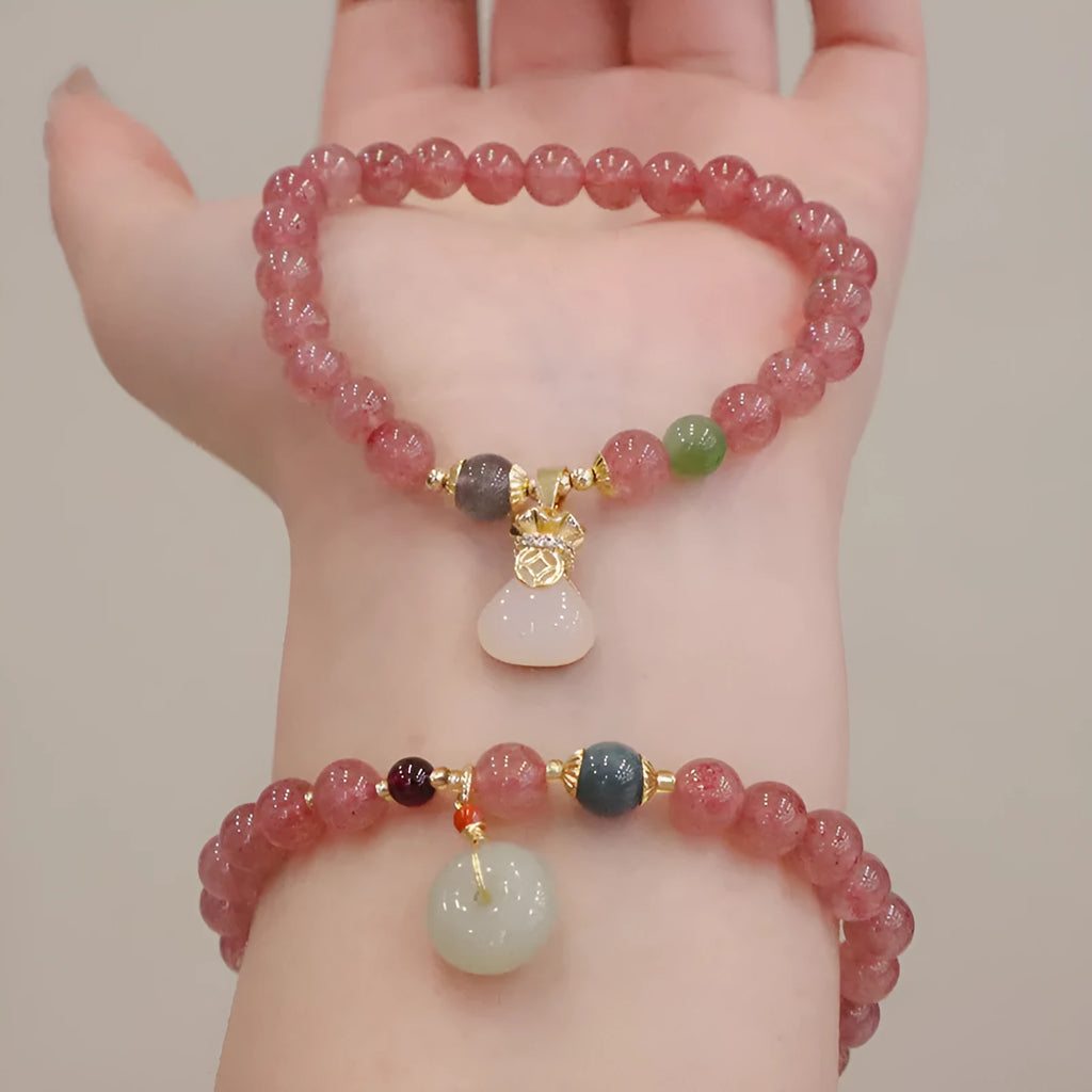 Geometric strawberry quartz women's bracelet with a lucky bag charm and silver safety buckle on a white background.