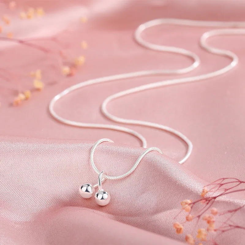 Silver cherry necklace for women on a snake bone chain, adjustable length.