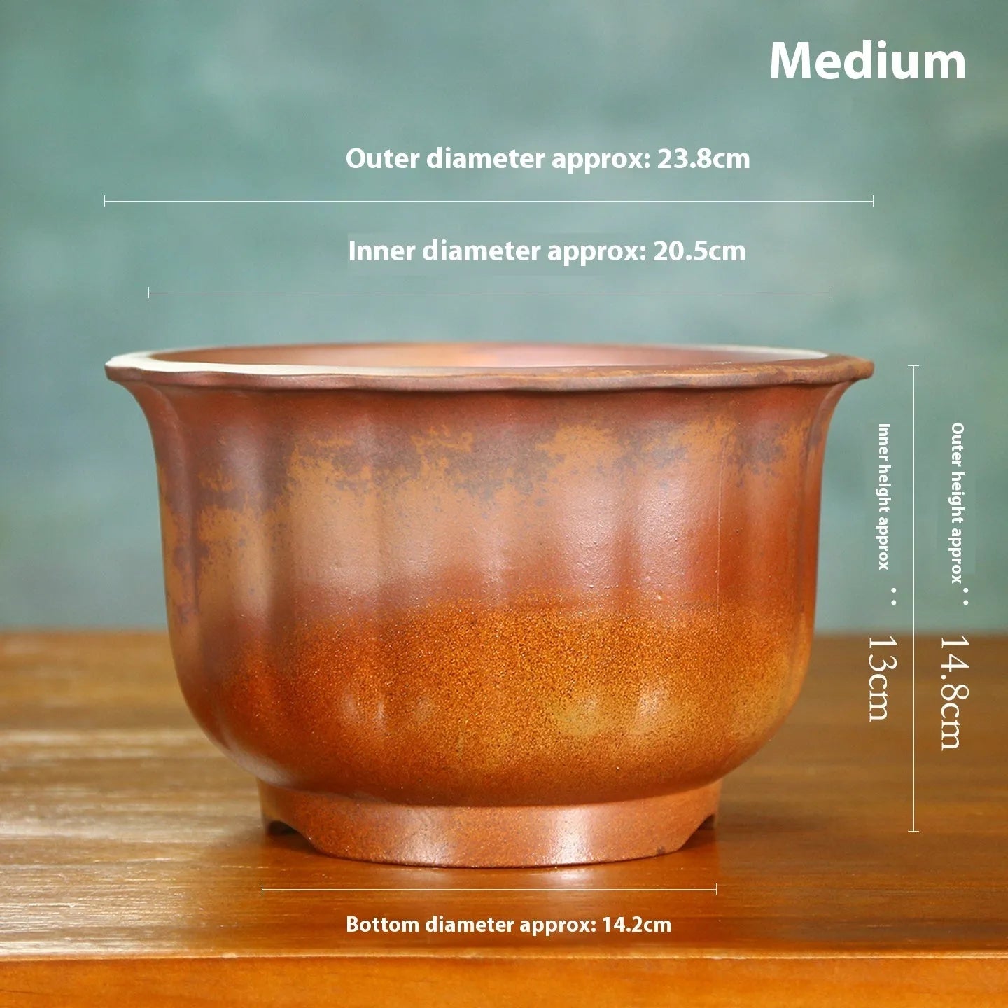 Antique carved ceramic flower pot with wood burning finish on a wooden table.