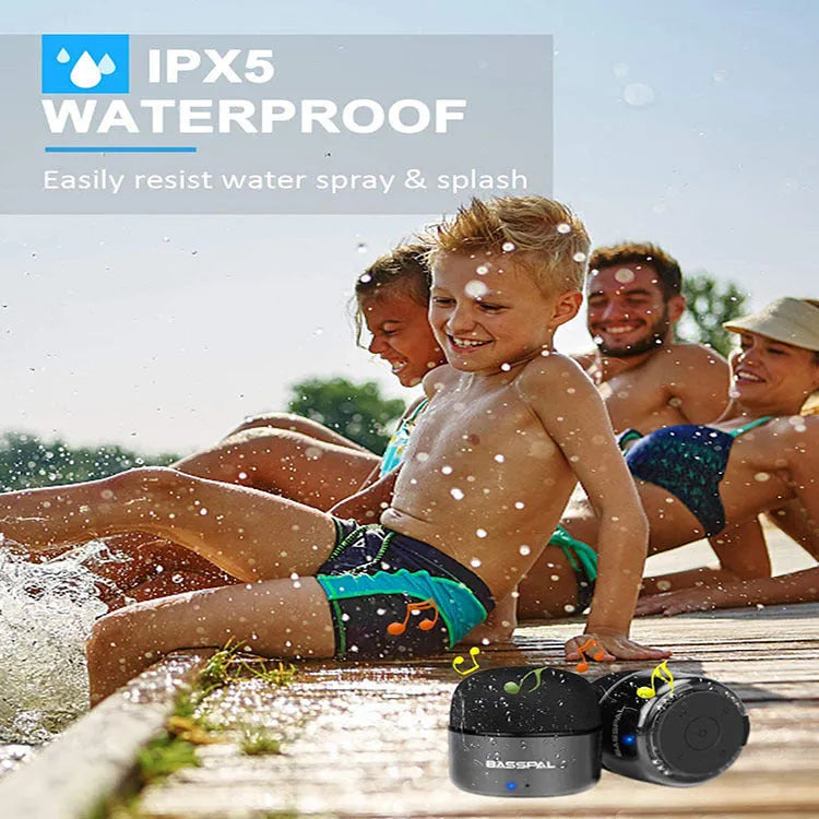 Black portable mini Bluetooth speaker with waterproof rating and control buttons.