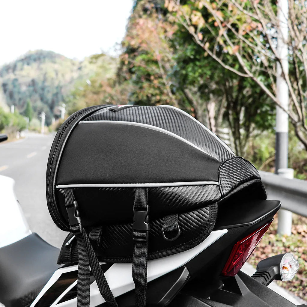 Black motorcycle seat bag with reflective lines and adjustable hooks for fuel tank or rear seat mounting