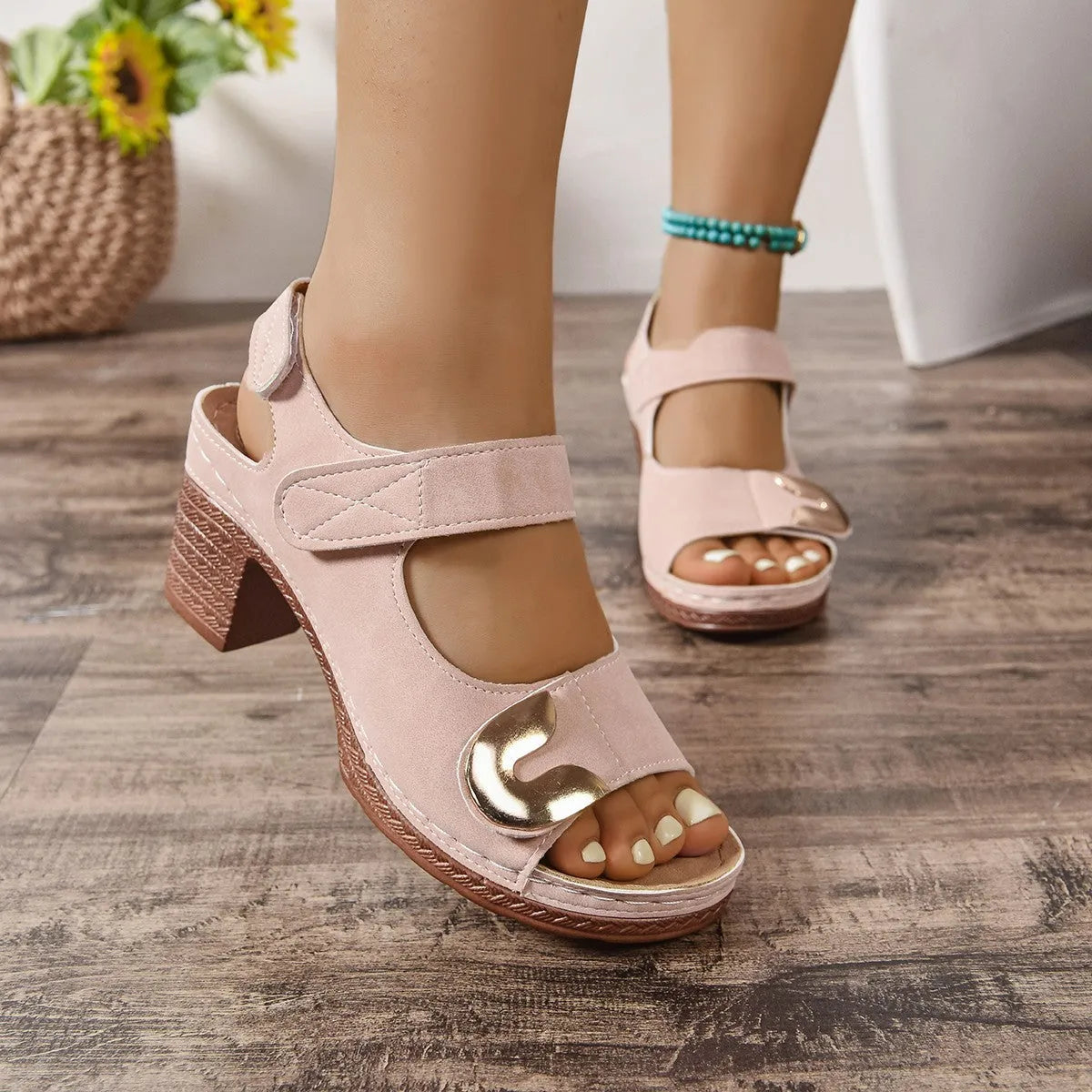 A pair of light brown Roman-style sandals with a round toe and a single adjustable Velcro strap across the instep.