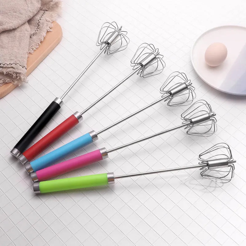 Self spinning whisk with stainless steel head and black handle on a white background