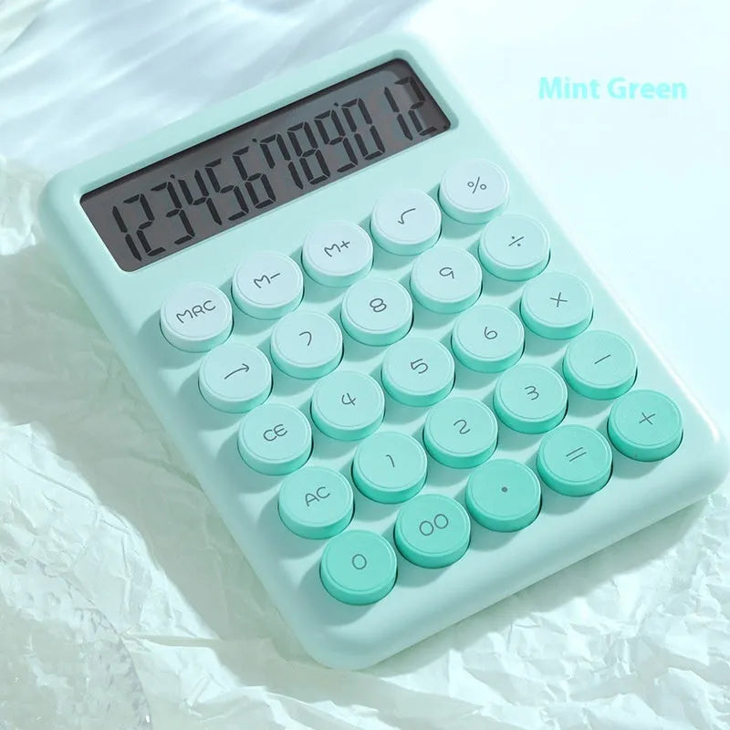 Gradient colour desktop calculator in violet, pink, blue, and green shades on a desk.