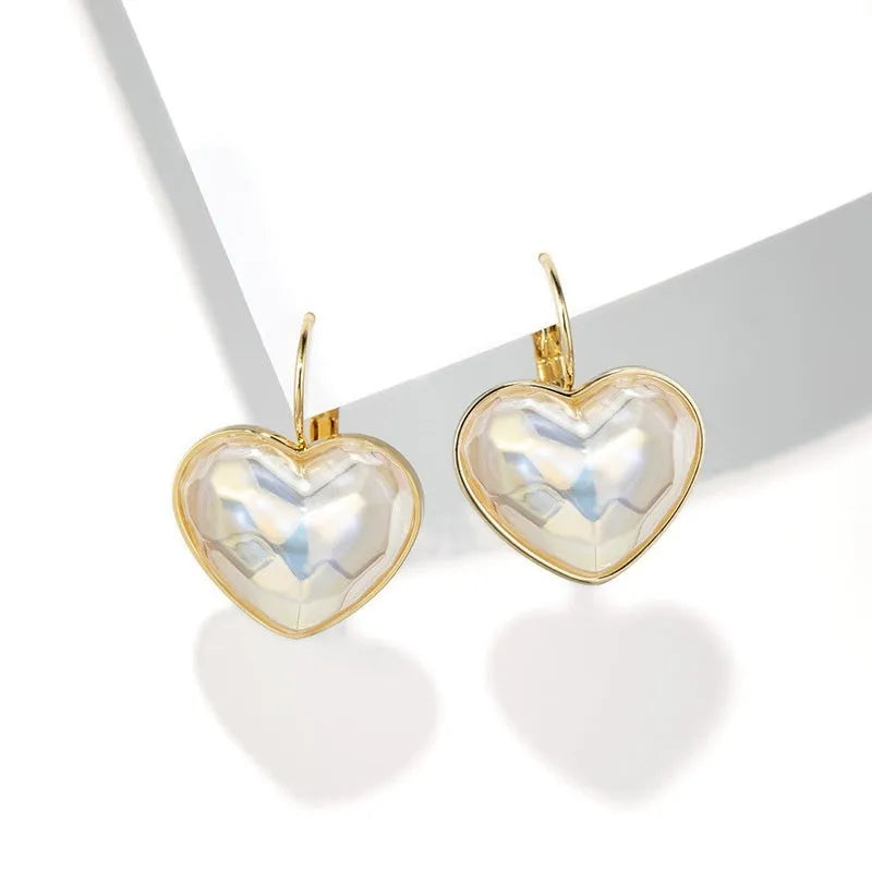 A pair of gold coloured alloy clip-on ear clip earrings for women.