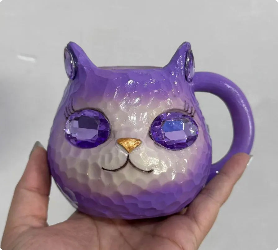 Colourful resin cat cup figurine on a shelf, shown in purple, green, blue, and pink colour options.