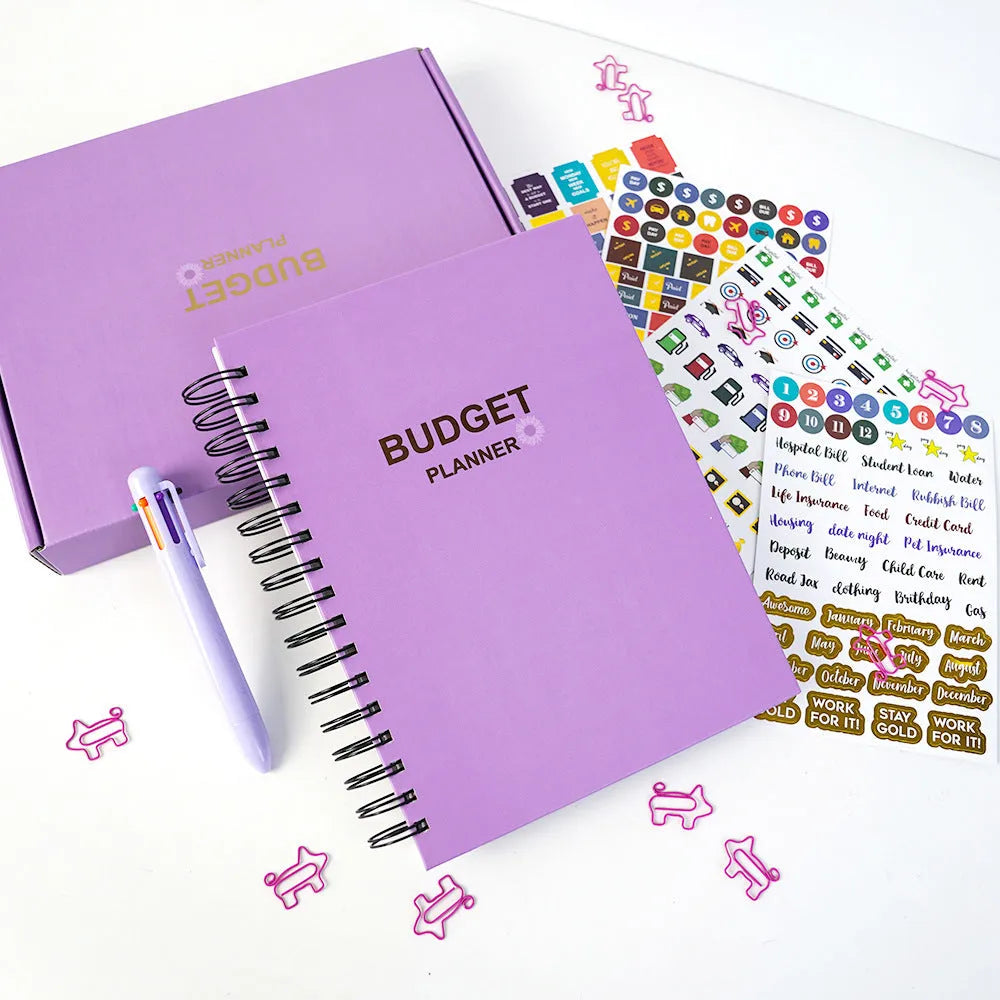 J12 purple coil-bound budget book open showing Daolin paper pages with financial tracking stickers and paper clips