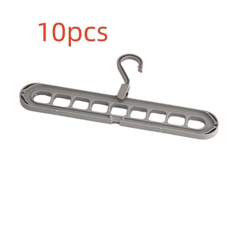 Green nine-hole plastic folding hanger for trousers and skirts showing multiple garment hanging points