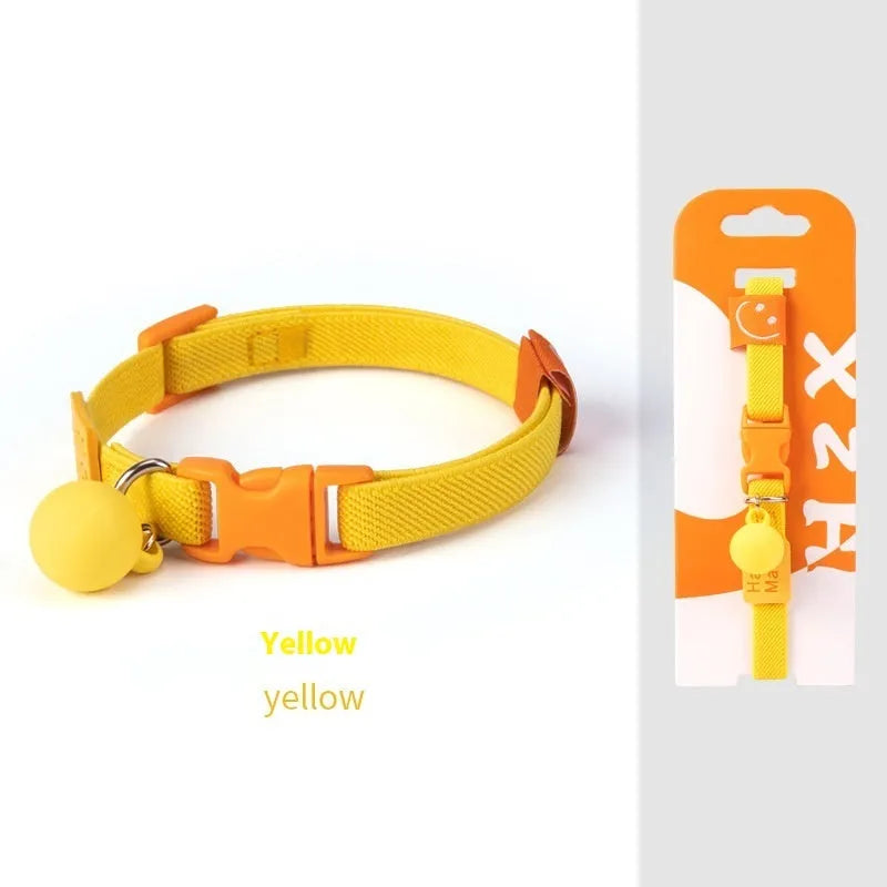 A stretchy yellow polyester dog collar for small breeds, shown adjusted to fit, with a metal D-ring.